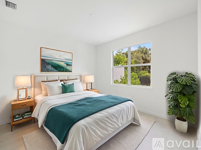 A bedroom with a large bed and a painting on the wall.
