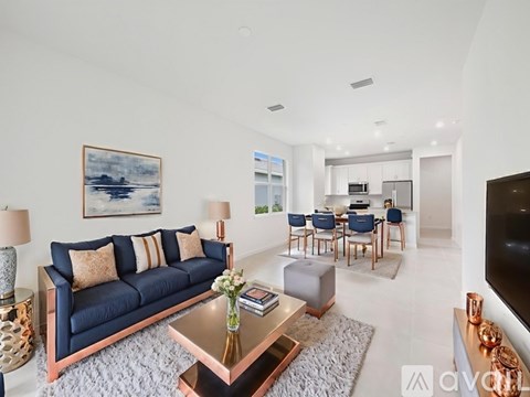 A living room with a blue couch and a coffee table.