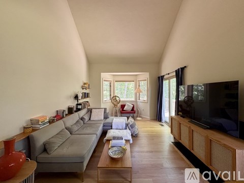 A living room with a grey sofa and a wooden coffee table.