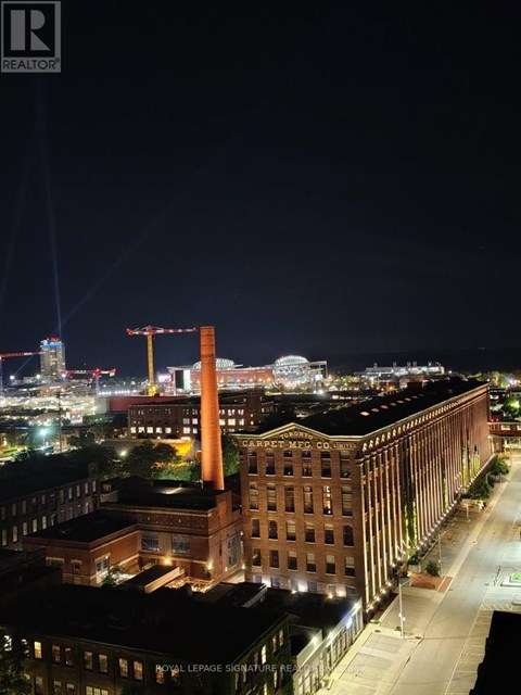 A nighttime cityscape with a large building in the foreground.