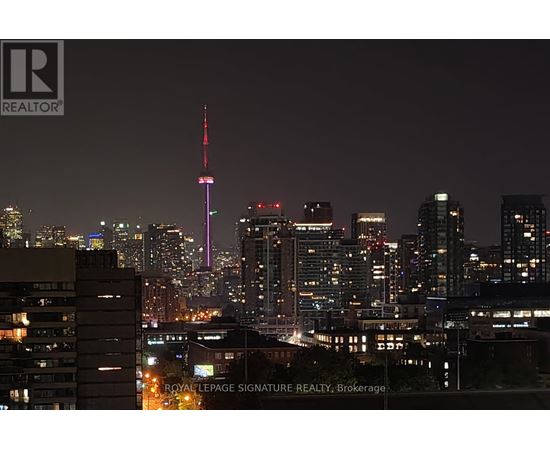 A cityscape at night with the CN Tower prominently lit up.