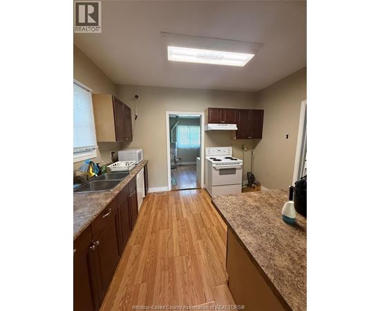 A kitchen with wooden floors and a counter top.