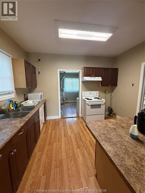 A kitchen with wooden floors and a counter top.