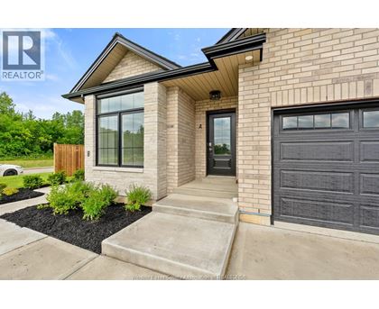 A house with a black garage door is for sale.