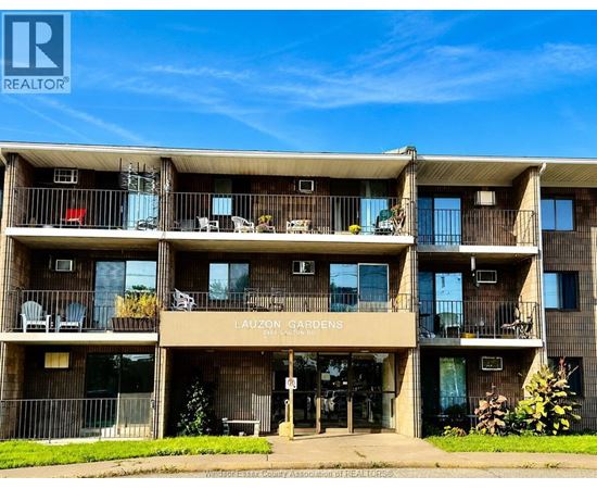 A multi-story apartment building named Lauzon Gardens is shown with balconies and outdoor furniture.