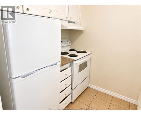 A white refrigerator and stove in a kitchen.