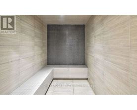 A tiled shower area with a glass door.