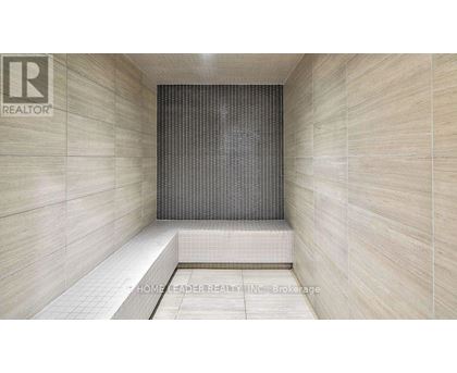 A tiled shower area with a glass door.