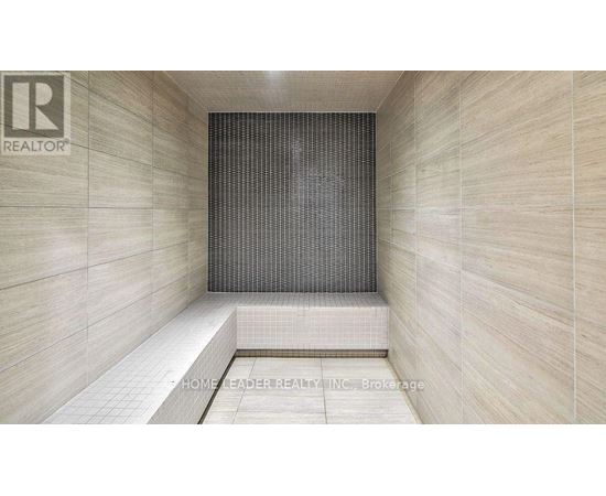 A tiled shower area with a glass door.
