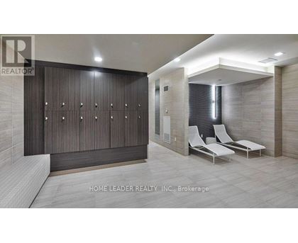 A brokerage office with a row of chairs and a wall of windows.