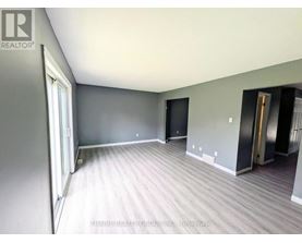 A room with grey walls and a wooden floor.