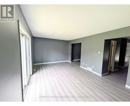 A room with grey walls and a wooden floor.