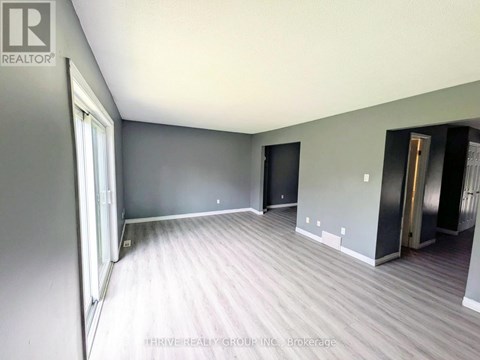 A room with grey walls and a wooden floor.