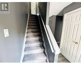 A staircase with a white door at the top.