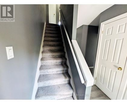 A staircase with a white door at the top.