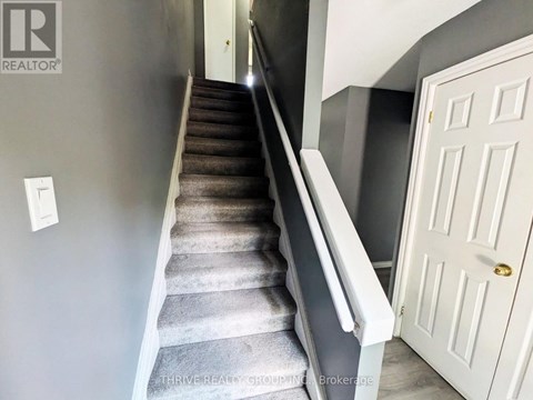 A staircase with a white door at the top.
