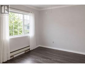A room with a window and curtains, with a Forest Hill Real Estate Inc. logo and Brokerage text.