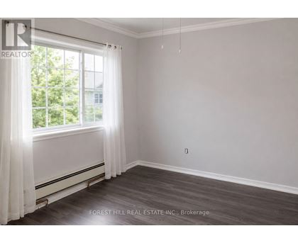 A room with a window and curtains, with a Forest Hill Real Estate Inc. logo and Brokerage text.