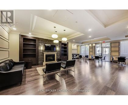 A spacious living room with a fireplace and a television.