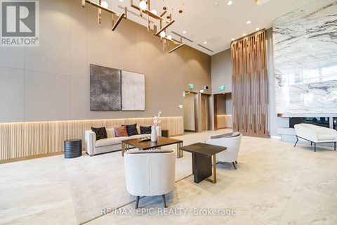 A modern living room with a white sofa and a wooden coffee table.