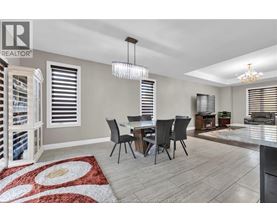 A dining room with a table set for four.