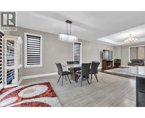 A dining room with a table set for four.
