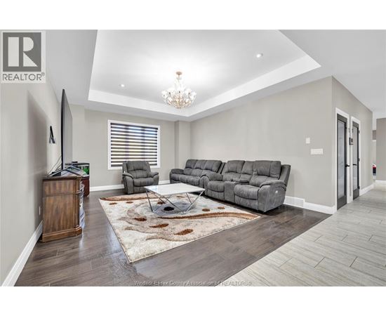 A living room with a grey sofa and a wooden cabinet.
