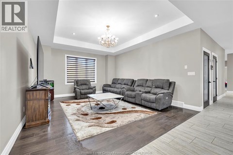 A living room with a grey sofa and a wooden cabinet.