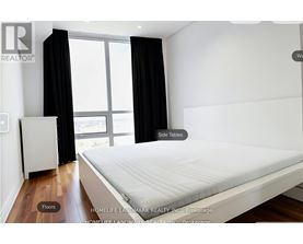 A room with a white desk and a black chair.