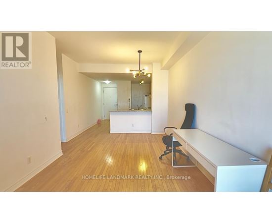 A room with a white desk and a black chair.