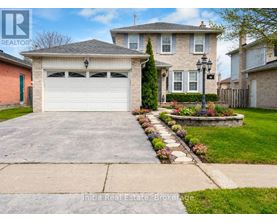 A house with a garage and a well-maintained lawn.