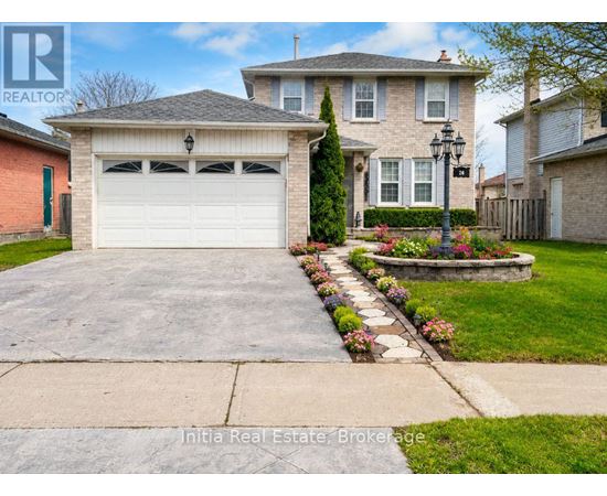 A house with a garage and a well-maintained lawn.