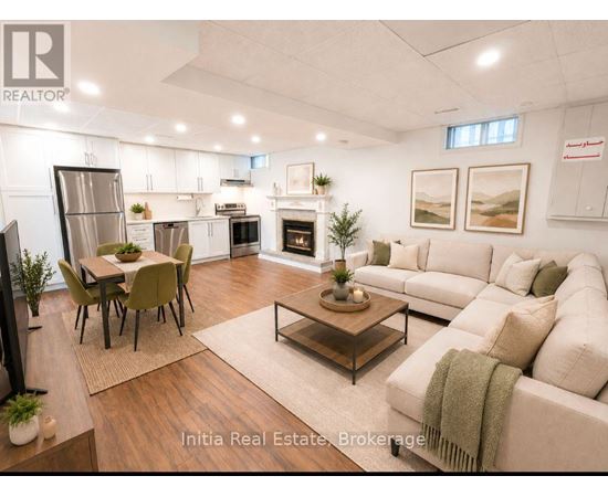 A well-lit, modern living room with a dining area and a fireplace.