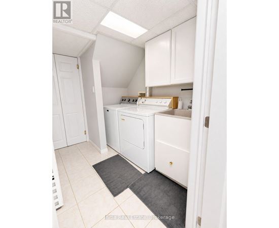 A kitchen with white appliances and cabinets.