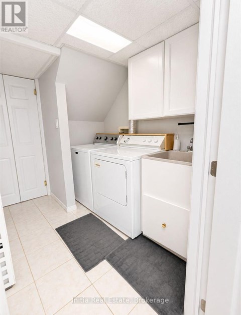 A kitchen with white appliances and cabinets.