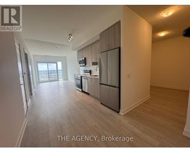 A spacious kitchen with a refrigerator, microwave, and dishwasher.