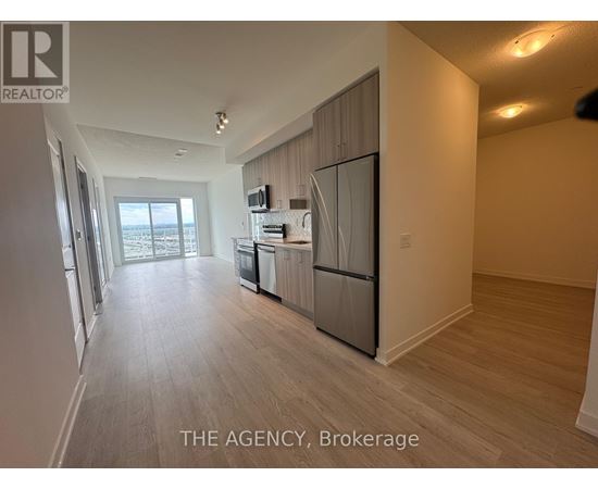 A spacious kitchen with a refrigerator, microwave, and dishwasher.