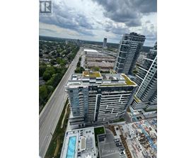 A large building with a pool in front of it.