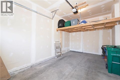 A room under construction with a fan and a shelf.