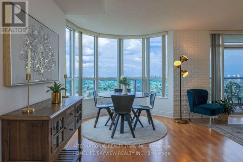 A dining room with a view of the ocean through large windows.