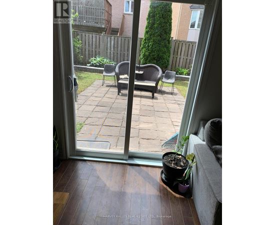 A patio with a table and chairs is visible through a glass door.