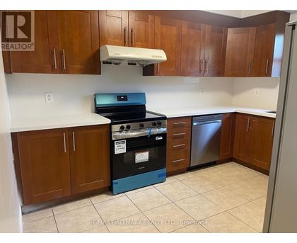 A kitchen with a stove top oven and a dishwasher.