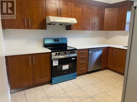 A kitchen with a stove top oven and a dishwasher.