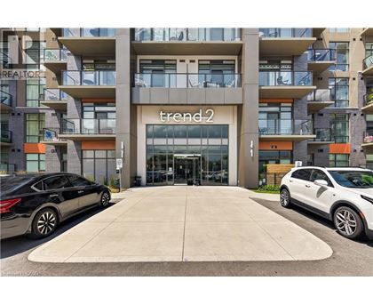 A black car is parked in front of a building with a sign that reads "trend2".