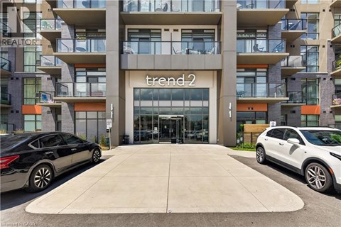 A black car is parked in front of a building with a sign that reads "trend2".