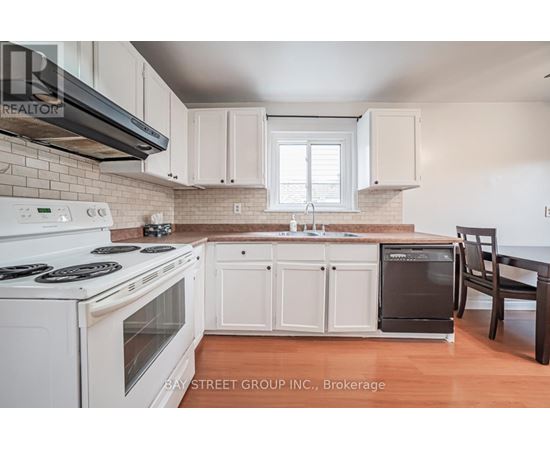 A kitchen with white appliances and cabinets.