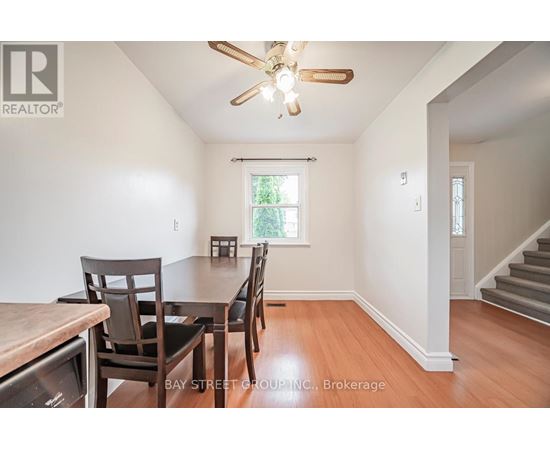 A dining room with a table and chairs.