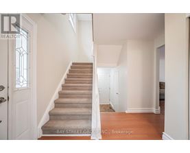 A staircase with a carpeted runner and white walls.