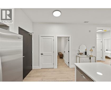A spacious, well-lit room with a large white counter and a wooden bench.