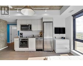 A modern kitchen with stainless steel appliances and white cabinetry.
